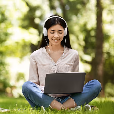Woman looking at her laptop outside